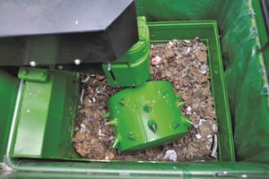  Compaction roller at work in the Bergmann Roto Compactor, above the compact engine hood of the compacting unit 