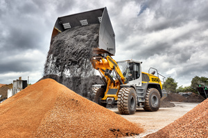  An L 556 XPower® with industrial kinematics and high dump bucket loading soil and substrate 