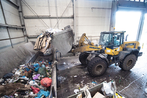  Front-end loaders pick up the mixed municipal waste and take it to a conveyor system which feeds the new pre-shredder 